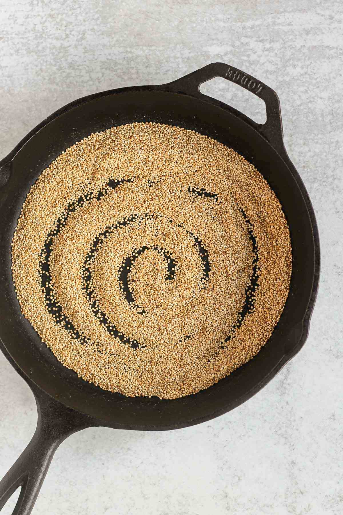 Crispy quinoa in a cast iron skillet.