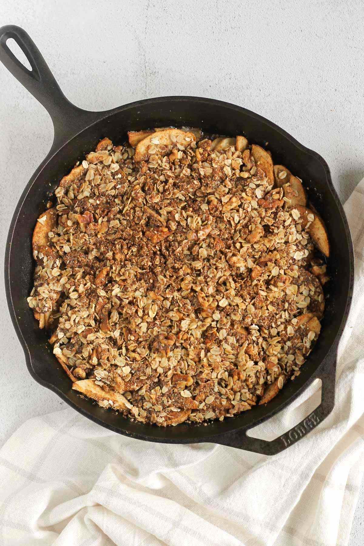 Apple crisp in a cast iron skillet after being baked.