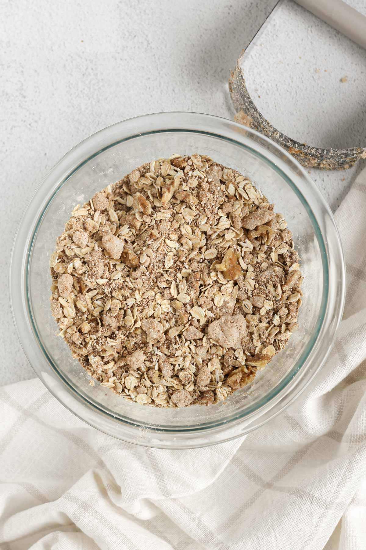 Apple crisp topping in a glass mixing bowl.