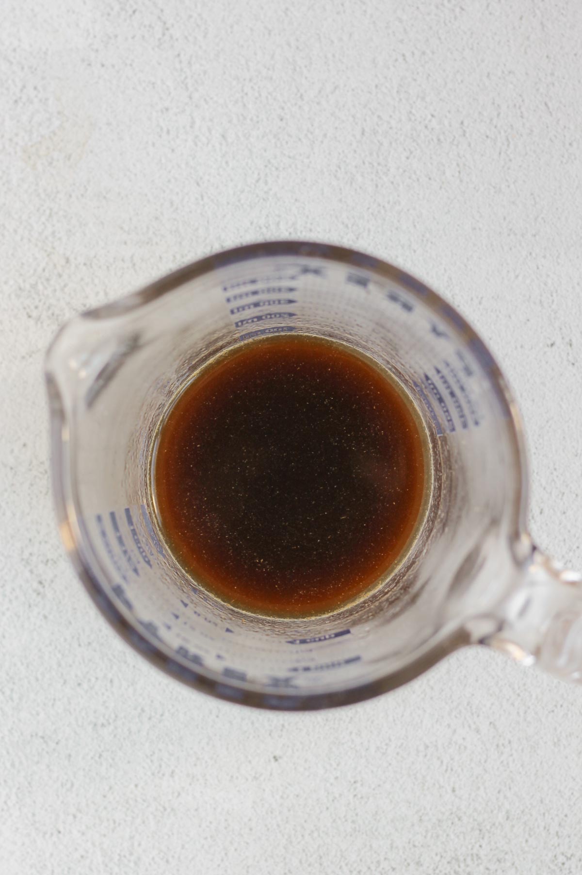 Teriyaki sauce ingredients whisked together in a glass measuring cup.