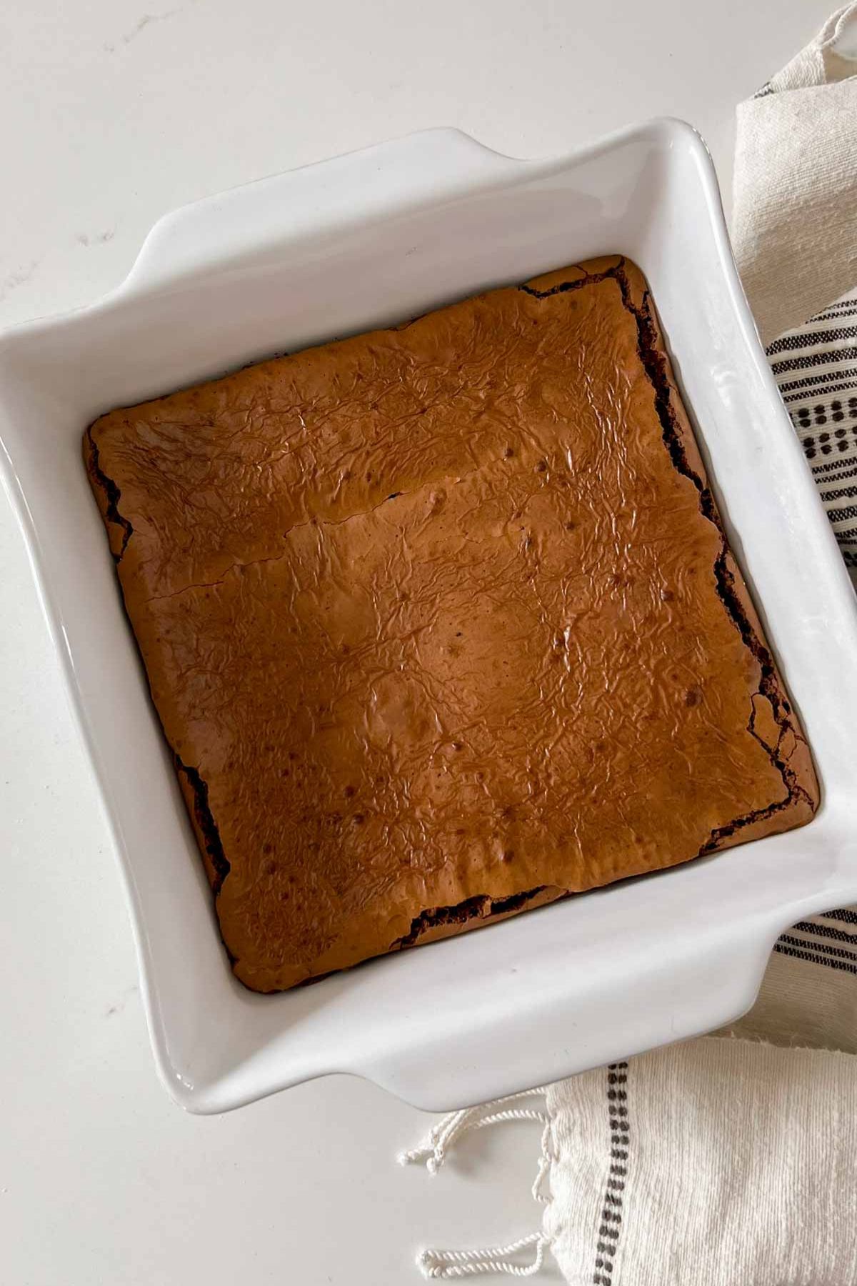 Cooked oat flour brownies in an 8x8 ceramic baking dish.