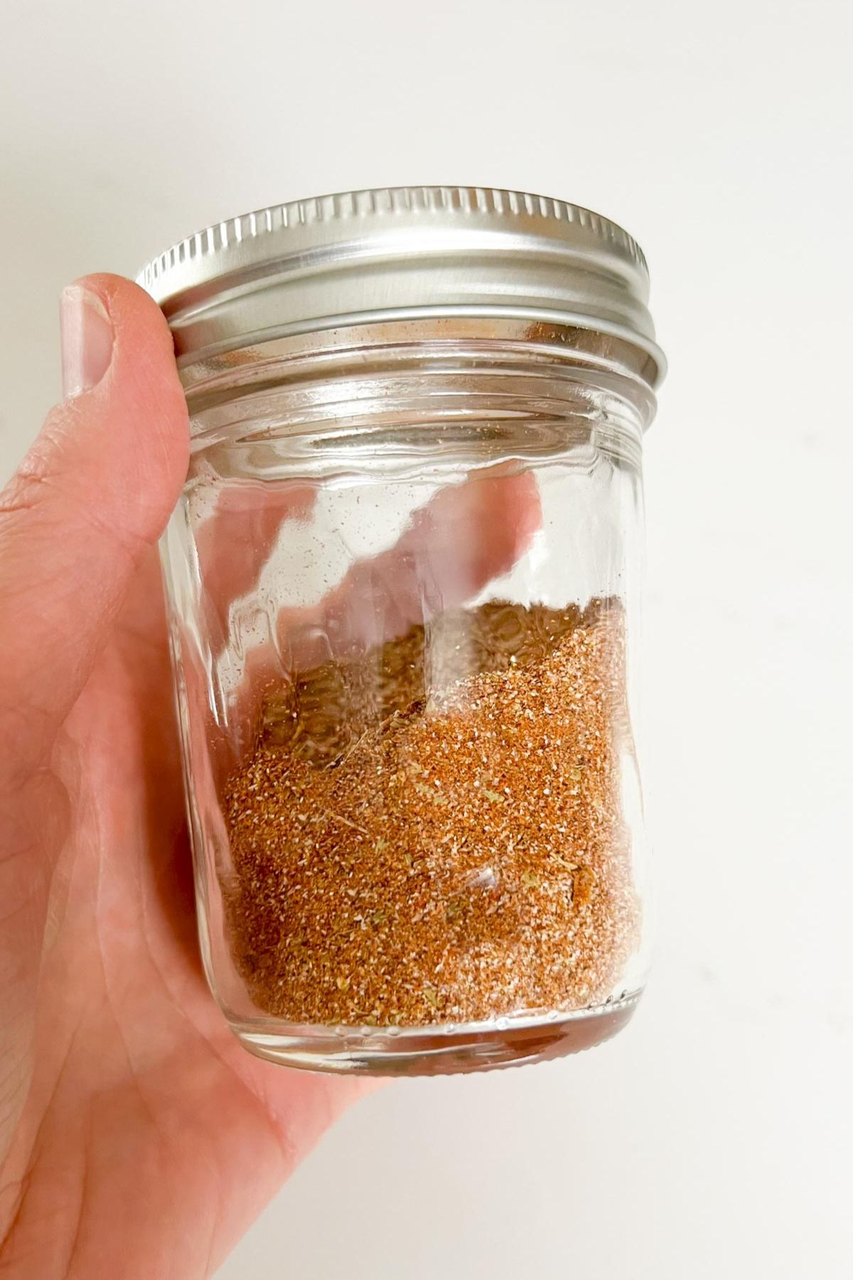 Taco seasoning mixed in a covered mason jar.