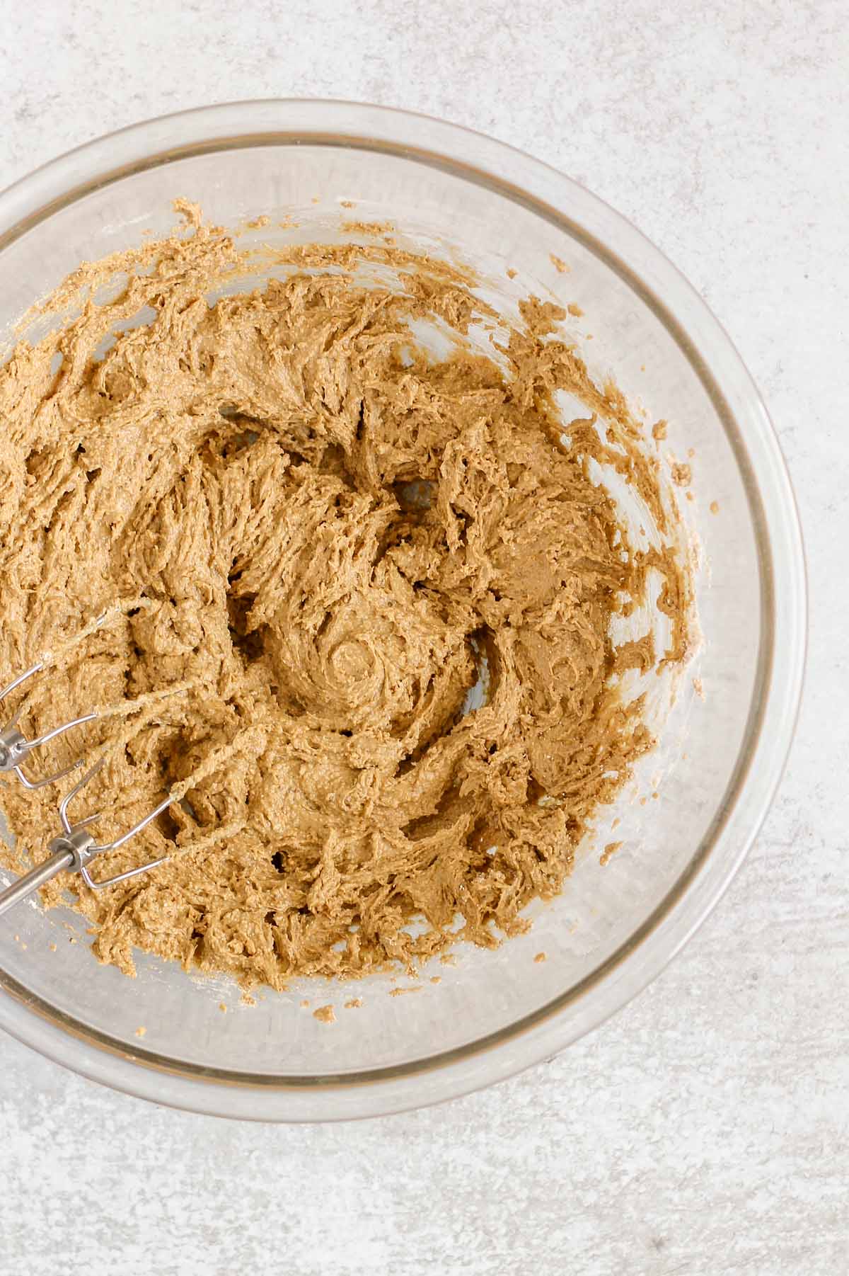 Oat flour cookie dough mixed in a large glass mixing bowl.
