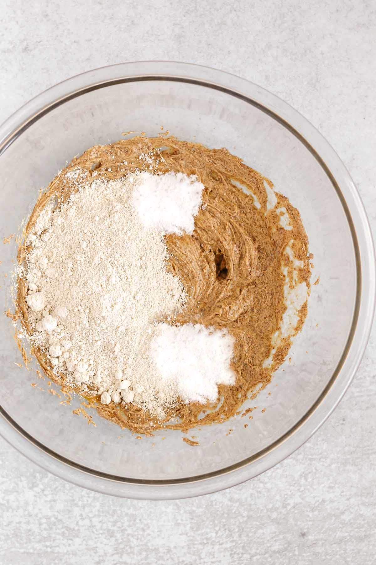 Oat flour cookie wet ingredients blended with oat flour, baking soda and tapioca flour added to the bowl.