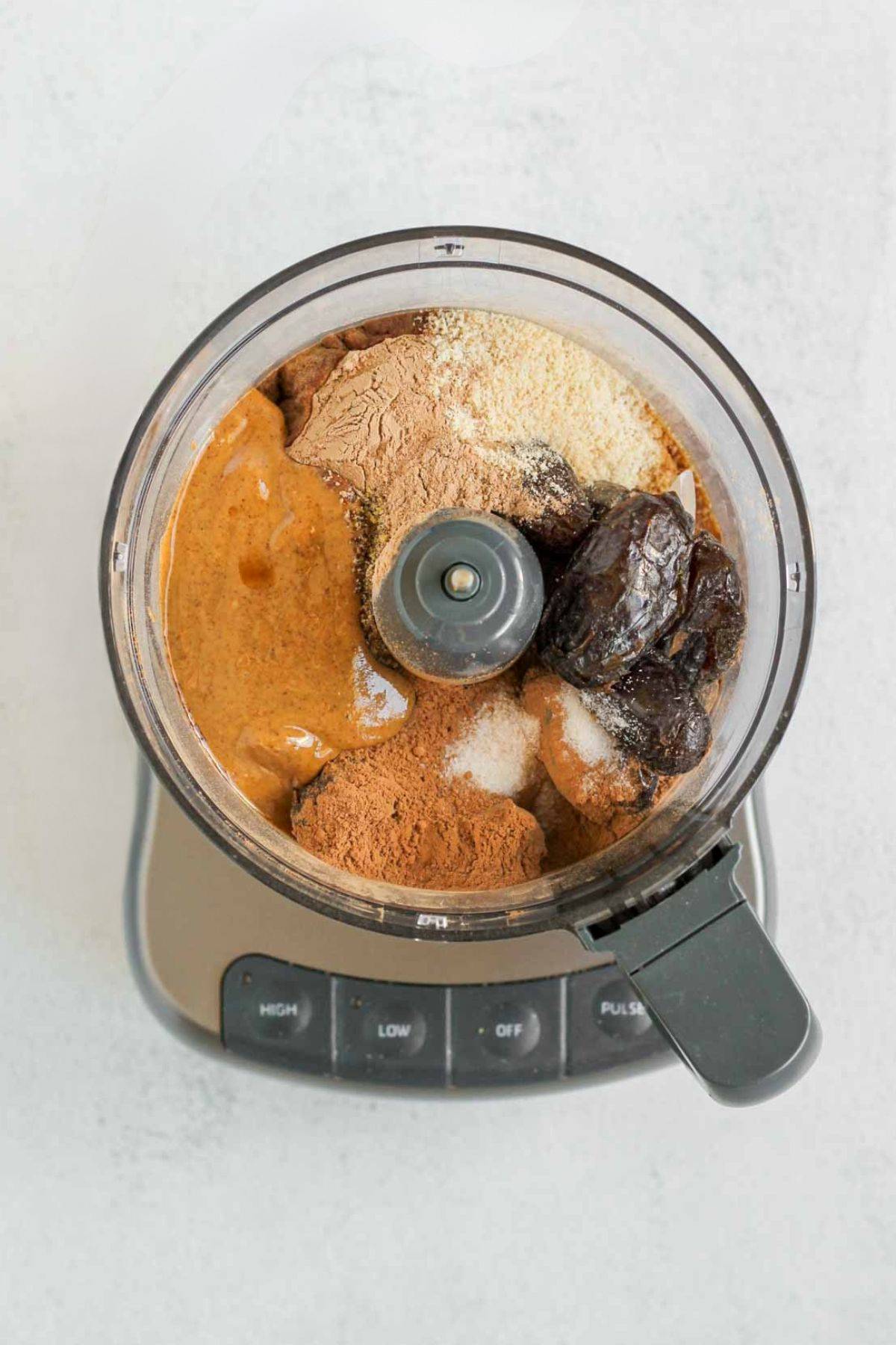 Ingredients for protein brownie bites in a food processor before being combined.