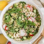 Asparagus quinoa salad in a large ceramic serving bowl.