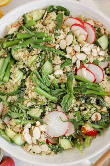 Asparagus quinoa salad in a large ceramic serving bowl.