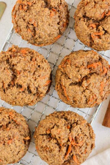 Carrot cake muffins on a wire cooling rack.