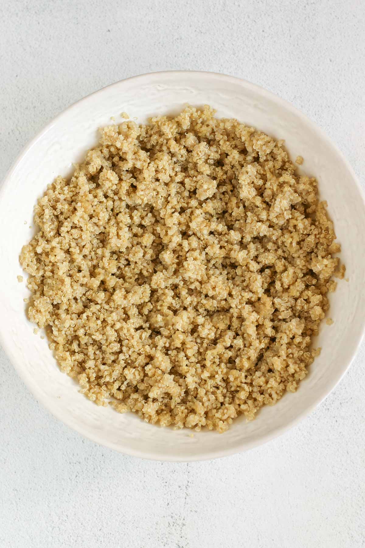 Cooked quinoa in a shallow ceramic serving bowl.