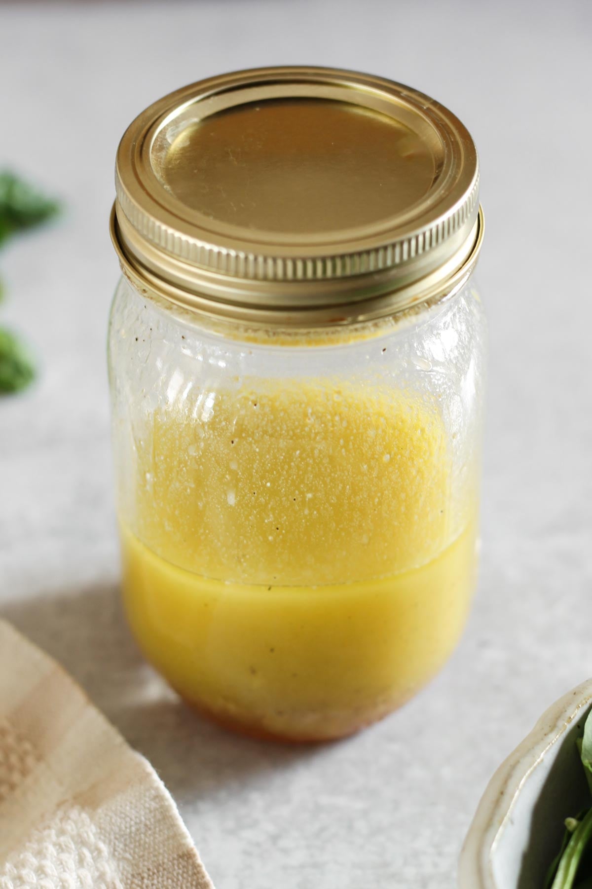 Lemon honey dressing shaken in a covered mason jar.