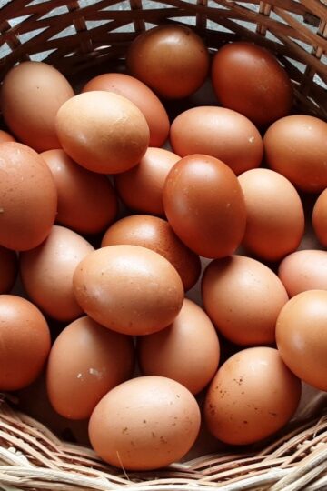 Brown eggs in a wicker basket.