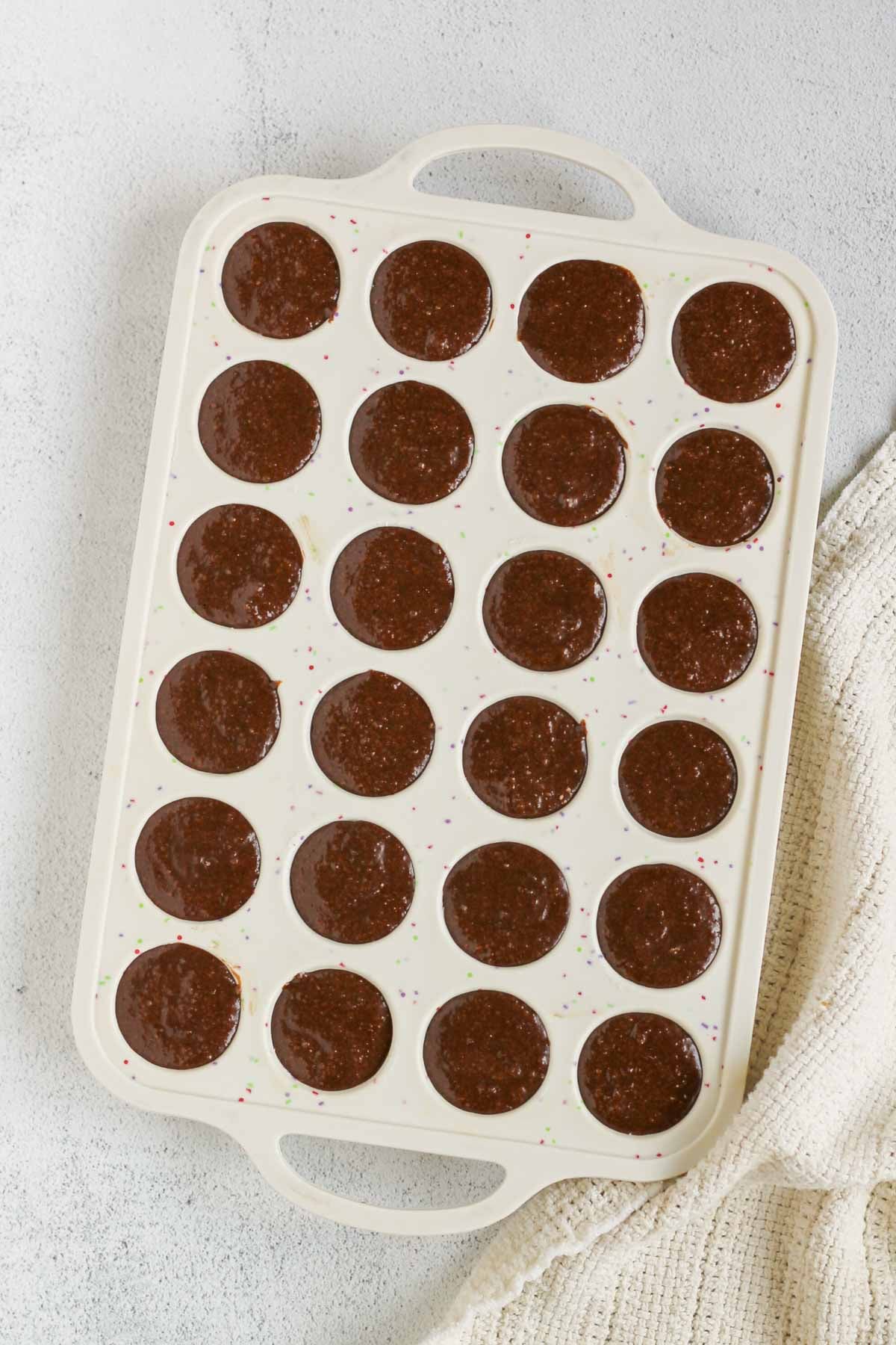 Flaxseed muffin batter in a 24-cup silicon mini muffin pan.