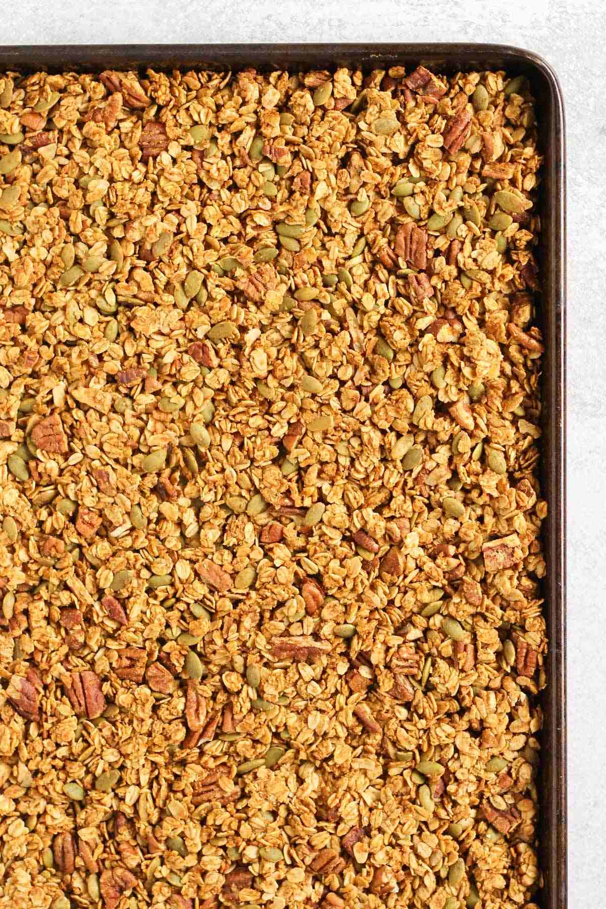 Baked pumpkin granola on a sheet pan.