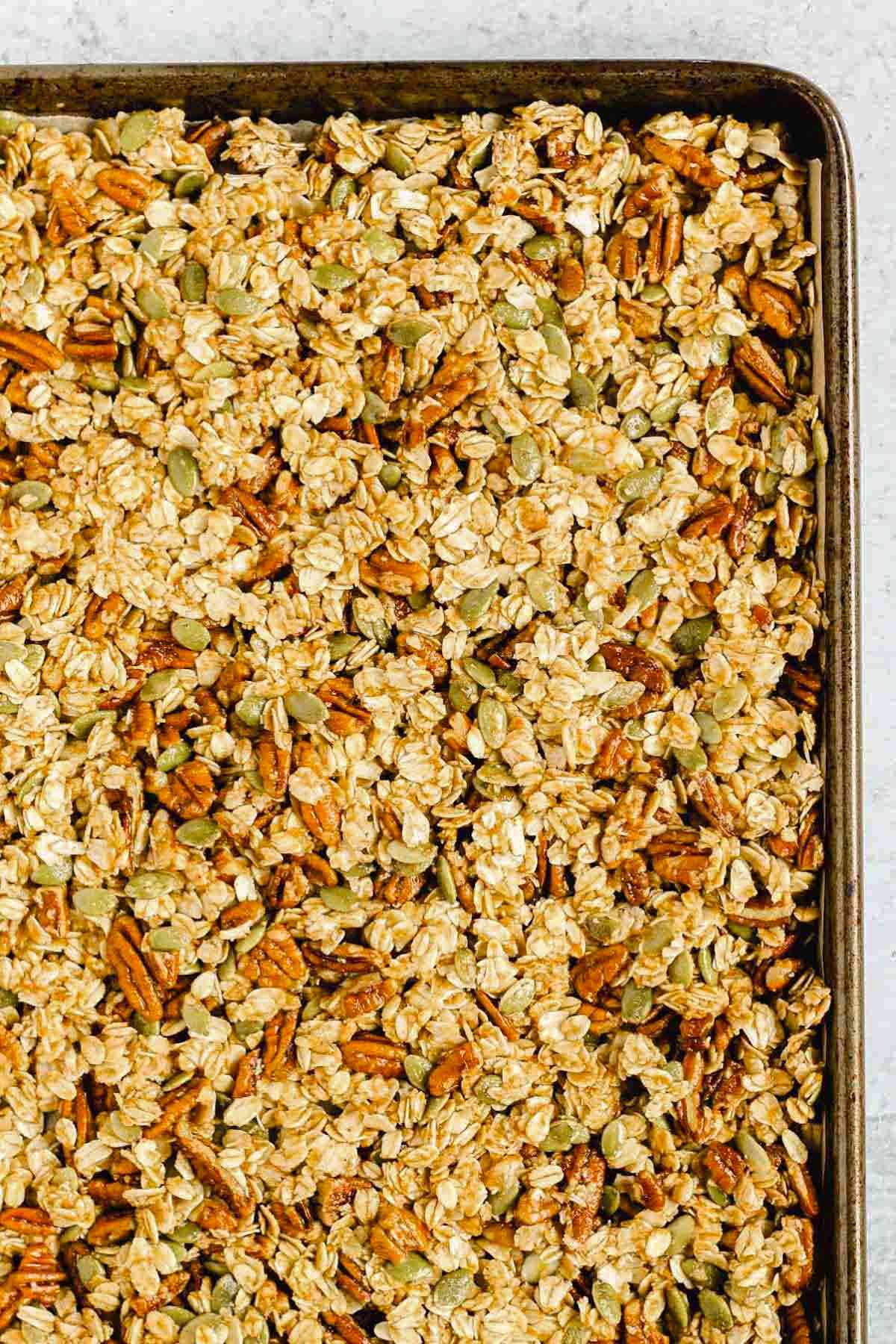 Pumpkin granola on a sheet pan before being baked.